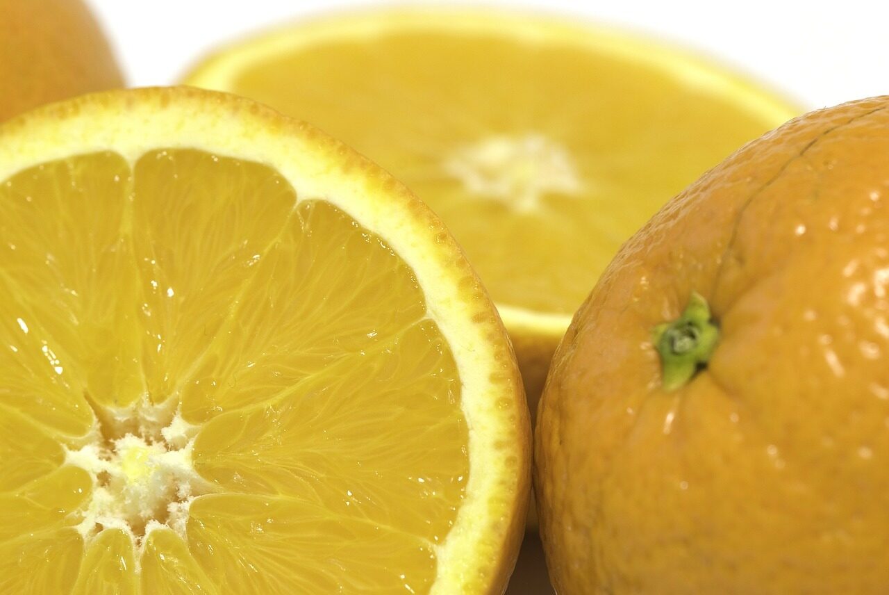 Appelsiner, en halvert og en hel